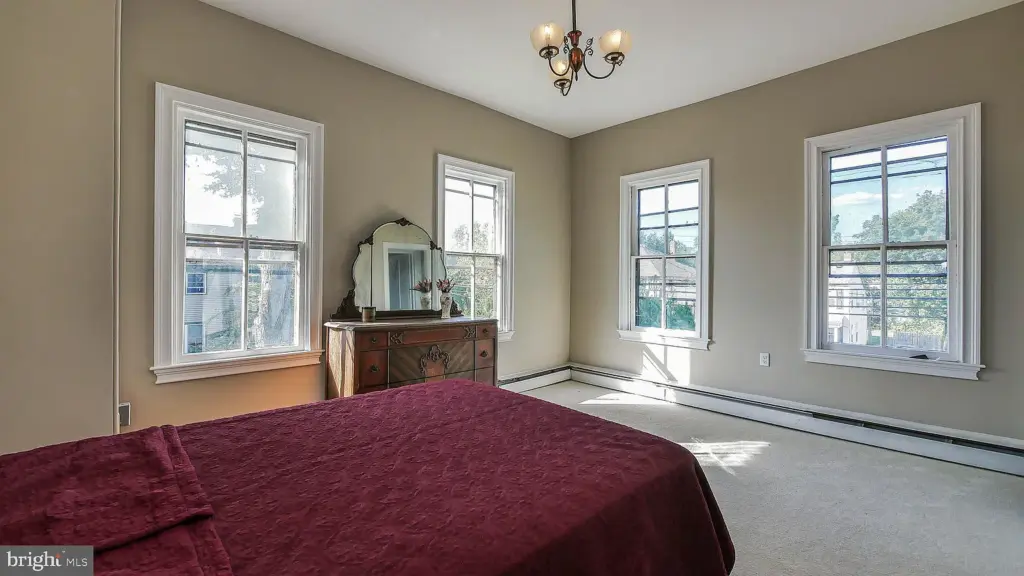 Restored bedroom inside the historic Abbott House following rehabilitation and preservation work.