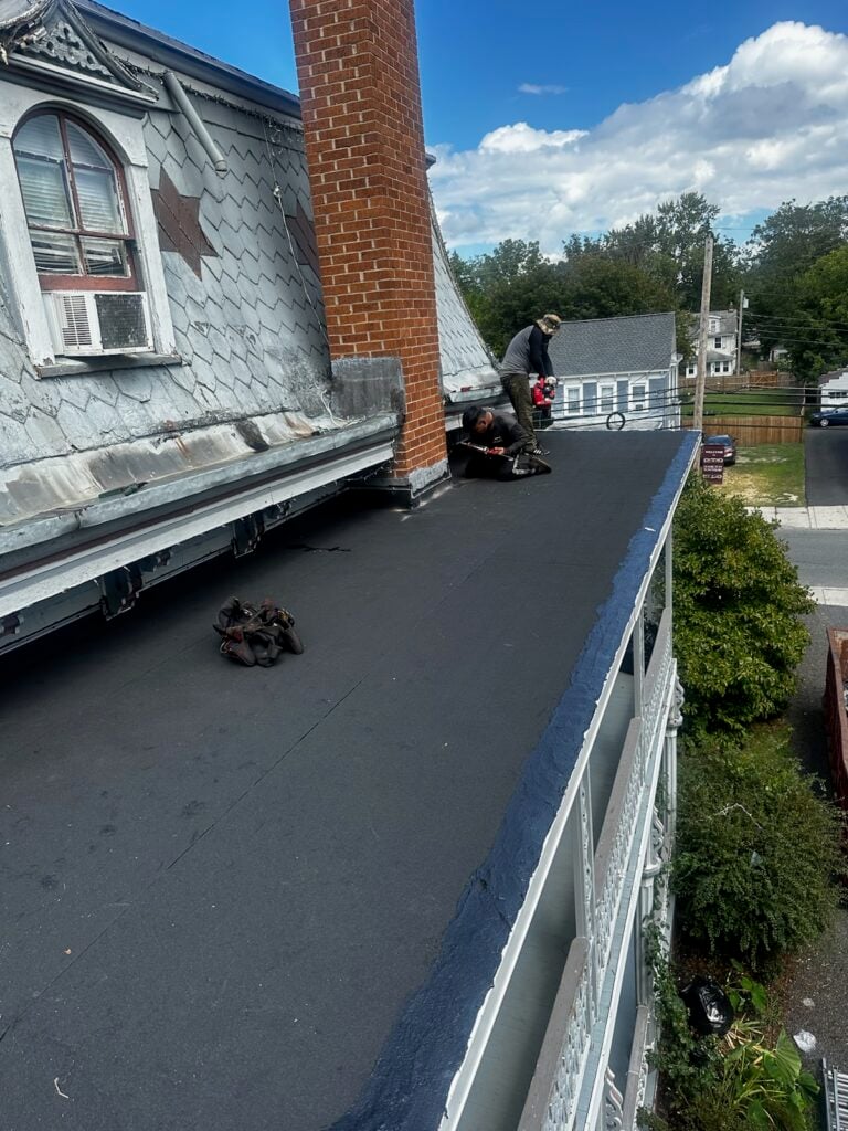Roof restoration work underway at the historic Abbott House during structural rehabilitation.