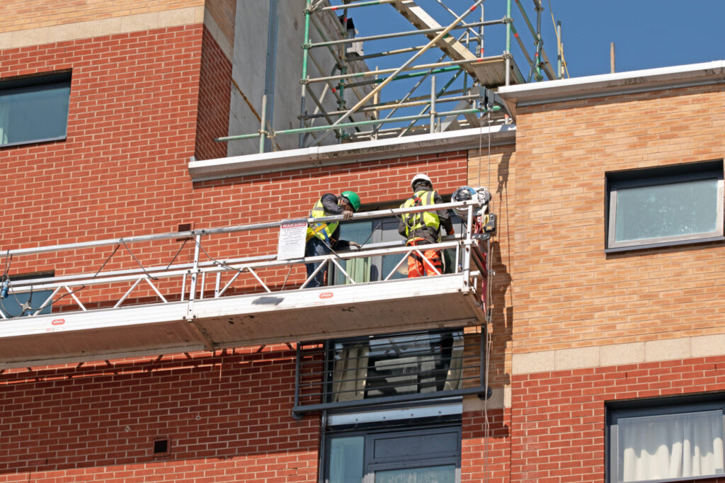 Workmen on a suspended platform