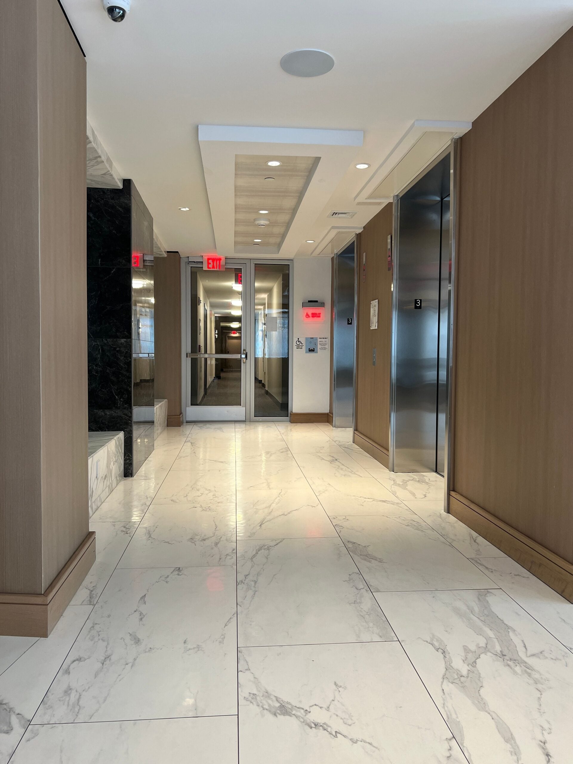Modern,Office,Building,Hallway,With,Marble,Flooring,And,Elevator,Doors,